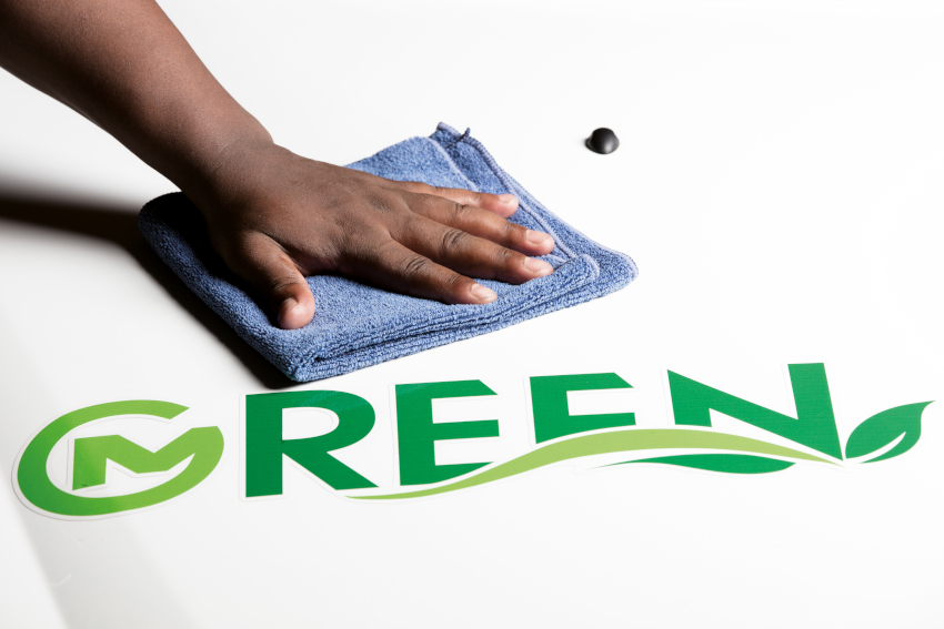 Person cleaning car with spray