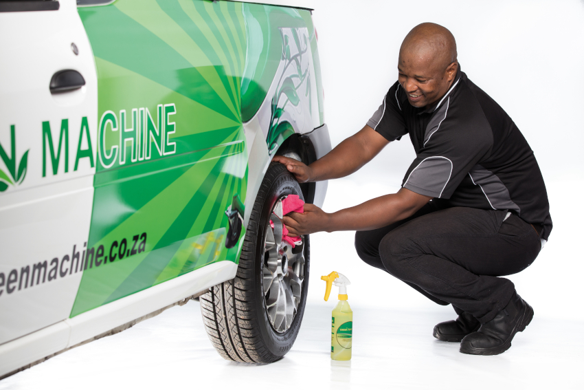 Person cleaning car with spray